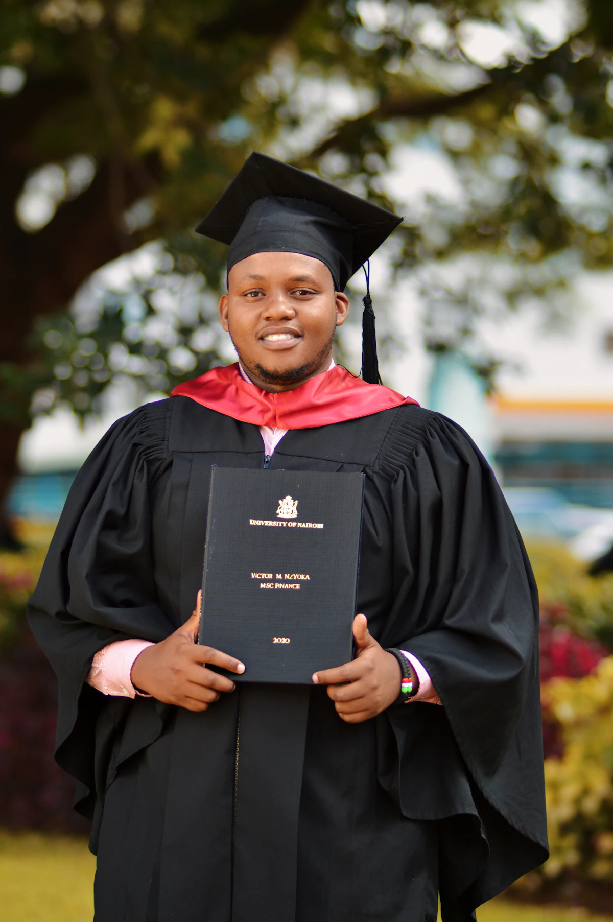 A proud graduate holding a certificate