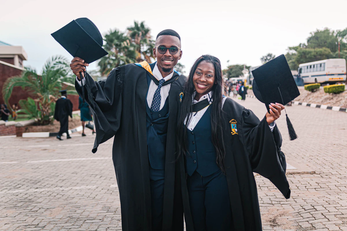 Two graduates celebrating in their gowns